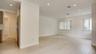 Open living area featuring wood-finish flooring, recessed lighting, and windows with vertical blinds