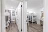 Interior rooms featuring wood-finish flooring, recessed lighting, and solid core doors with matte black hardware