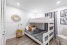 Room interior featuring wood-finish flooring, recessed lighting, and a closet with louvered doors