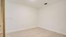 Neutral interior space featuring wood-finish flooring and louvered closet doors
