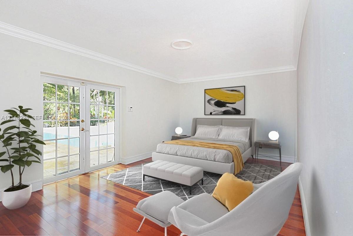 Interior space featuring wood-finish flooring, white crown molding, and glass-paneled double doors