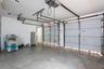 Multi-car garage featuring dual overhead metal doors, concrete flooring, and an integrated automated door opener system
