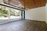 Covered patio featuring a wood-plank ceiling, structural columns, dual ceiling fans, and textured stone-finish flooring