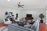 High ceilings featuring crown molding, recessed lighting, a ceiling fan, and wood-finish flooring