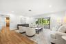 Living area featuring wood-finish flooring, recessed lighting, and expansive glass sliding doors