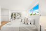 Room featuring wood-finish flooring, built-in floor-to-ceiling cabinetry, recessed lighting, and double-pane glass doors providing external access