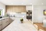 Kitchen featuring wood-finish upper cabinetry, light-toned stone-style countertops and backsplash, integrated stainless steel double wall oven, and a 