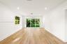 Interior space featuring wood-finish flooring, recessed lighting, a single-pane window, and large sliding glass doors providing access to the exterior