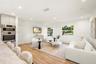 Living area featuring wood-finish flooring, recessed lighting, and integrated stainless steel double wall ovens