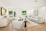 Living area featuring wood-finish flooring, recessed lighting, and multiple windows