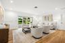 Living area featuring wood-finish flooring, recessed lighting, and large sliding glass doors providing outdoor access