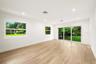 Neutral interior space featuring wood-finish flooring, recessed lighting, and large windows