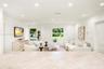 Neutral-toned countertop with integrated breakfast bar, recessed lighting, and dual windows