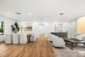Open-concept interior featuring wood-finish flooring, recessed lighting, and crisp white wall finishes