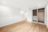 Wood-finish flooring, recessed lighting, and built-in cabinetry featuring integrated shelving and drawers