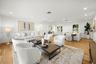 Open-concept interior featuring light-tone wood-finish flooring, recessed lighting, and crisp white walls