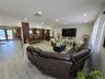 Open concept floor plan featuring recessed lighting, wood-finish flooring, decorative vertical pillar detailing, and double French doors