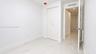 Stone-finish flooring, dual-panel closet doors, and recessed ceiling lighting