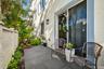 Private patio with slate gray tile and lush perimeter landscaping