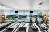 Fitness center with floor-to-ceiling windows, recessed lighting, and water scenery