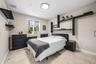 En-suite bedroom with full bath and walk-in closet with barn door