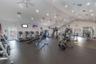 Fitness center featuring vaulted ceilings, recessed lighting, multiple ceiling fans, and impact-resistant rubber flooring