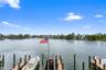 Waterfront property featuring multiple boat slips and a central dock-mounted flagpole