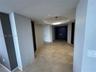 Interior space featuring large-format natural stone tile flooring, a recessed circular ceiling cove, circular LED flush-mount lighting, and solid-core