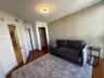 Room featuring wood-finish flooring, a built-in closet with integrated shelving, and a circular ceiling-mounted light fixture