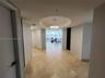 Entryway featuring large-format tile flooring, circular recessed ceiling detail, and integrated lighting fixtures