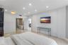 Interior room featuring recessed ceiling lighting, large-format polished stone flooring, and an integrated bathroom containing a soaking tub