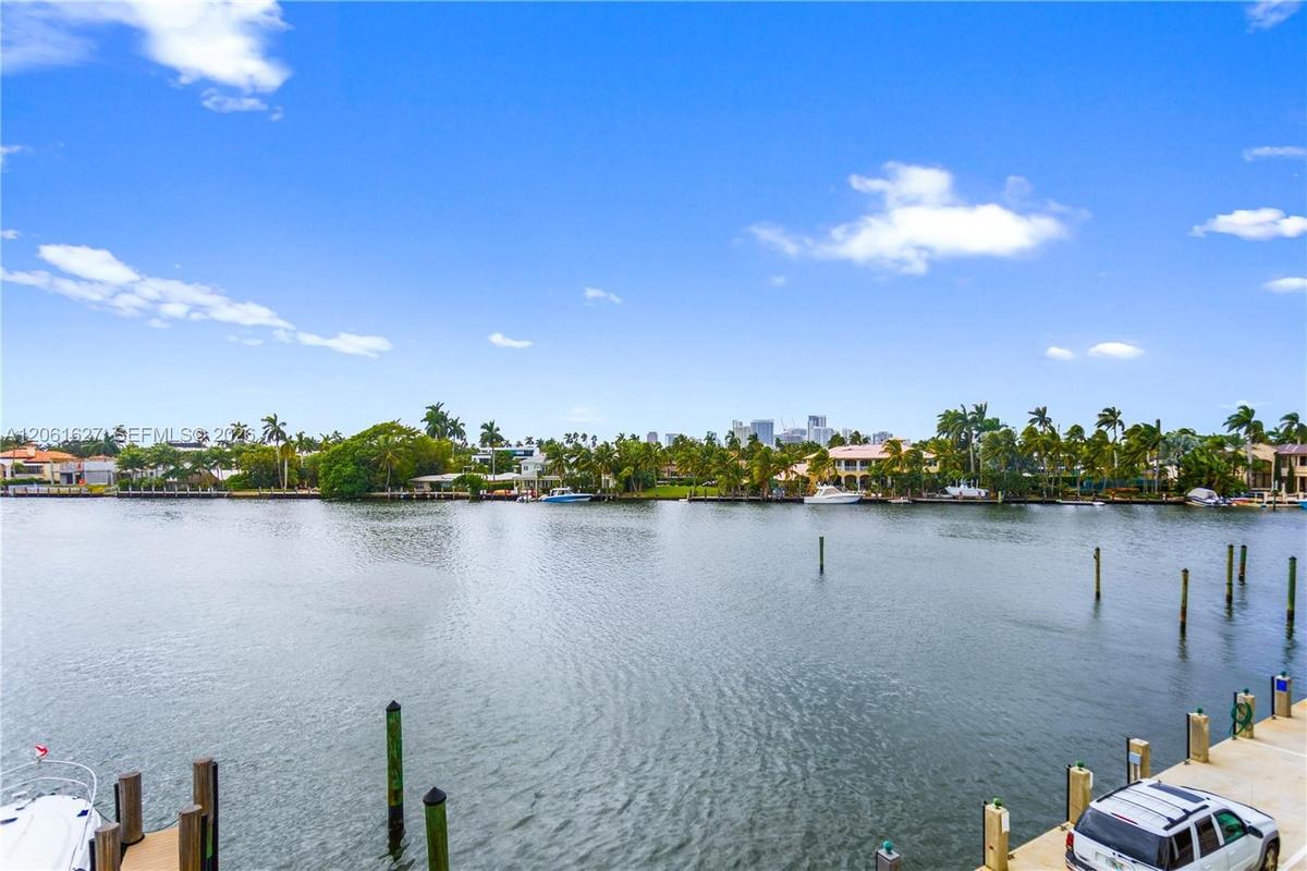 Waterfront property featuring a concrete bulkhead, deep-water dock pilings, and direct waterway access