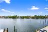 Waterfront property featuring a concrete bulkhead, deep-water dock pilings, and direct waterway access
