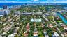 Aerial perspective of Miami Beach neighborhood with canopy of mature trees and proximity to the Atlantic Ocean