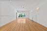 Interior space featuring wood-finish flooring, recessed lighting, wall-mounted light fixtures, and a decorative fireplace surround