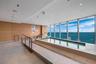Indoor pool with tile surround, wood-finish paneling, floor-to-ceiling windows, and recessed lighting