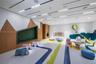 Custom wood-panel accent wall with integrated recessed seating, linear recessed ceiling lighting, smooth-finish flooring, and built-in wall niches