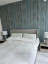 Textured blue wall covering and light-colored flooring