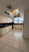 Kitchen featuring white cabinetry, dark countertops, tile flooring, an integrated wall oven, and a mirrored ceiling fixture with a hanging chandelier