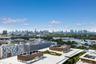 Elevated perspective showcasing an expansive urban skyline and coastal horizon