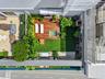 Private outdoor terrace featuring a wood-plank deck, integrated plunge pool, synthetic lawn, and perimeter landscaping