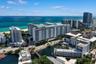 Aerial perspective featuring coastal proximity, high-rise architecture, urban infrastructure, and waterway access