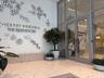 Entrance featuring floor-to-ceiling glass paneling, double-door entryway, terrazzo flooring, and decorative metallic wall art
