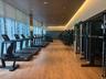 Fitness center featuring wood-finish flooring, floor-to-ceiling windows, recessed cove lighting, and wood-paneled ceiling detail