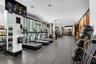 Fitness center featuring large-format floor tile, expansive floor-to-ceiling windows, recessed lighting, and wall-mounted mirrors