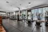 Fitness center featuring rubberized tile flooring, recessed lighting, and floor-to-ceiling windows