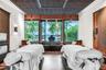 Custom-designed recessed ceiling with decorative screen detailing, built-in wooden wall paneling, large-format picture windows, and integrated soaking