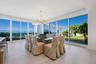 Open floor plan featuring floor-to-ceiling glass sliding doors, wood-finish flooring, recessed lighting, and a multi-globe branching chandelier