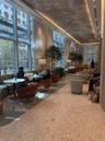 Floor-to-ceiling windows, terrazzo flooring, recessed cove lighting, and decorative ceiling treatment