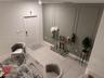 Entryway featuring neutral tile flooring, a six-panel door, and an accent wall with decorative picture frame molding